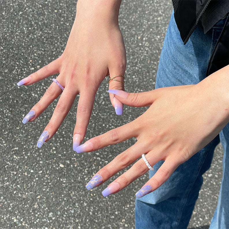 IVY BEAUTY by KISS trendy press on nails lavender ombre with white marble floral accents on hands