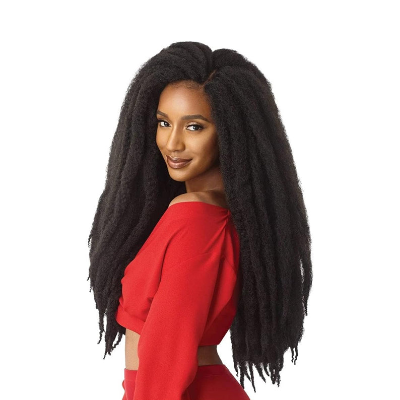 Woman wearing OUTRE X-Pression Natural Kinky Twist hair in long, voluminous black braids