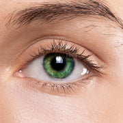 Close up eye wearing LIZ green color contact lenses showing natural vibrant green iris enhancement for makeup looks