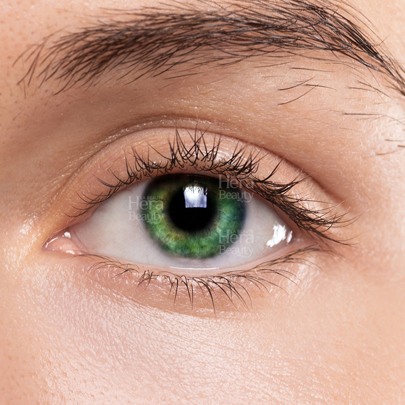 Close up eye wearing LIZ green color contact lenses showing natural vibrant green iris enhancement for makeup looks