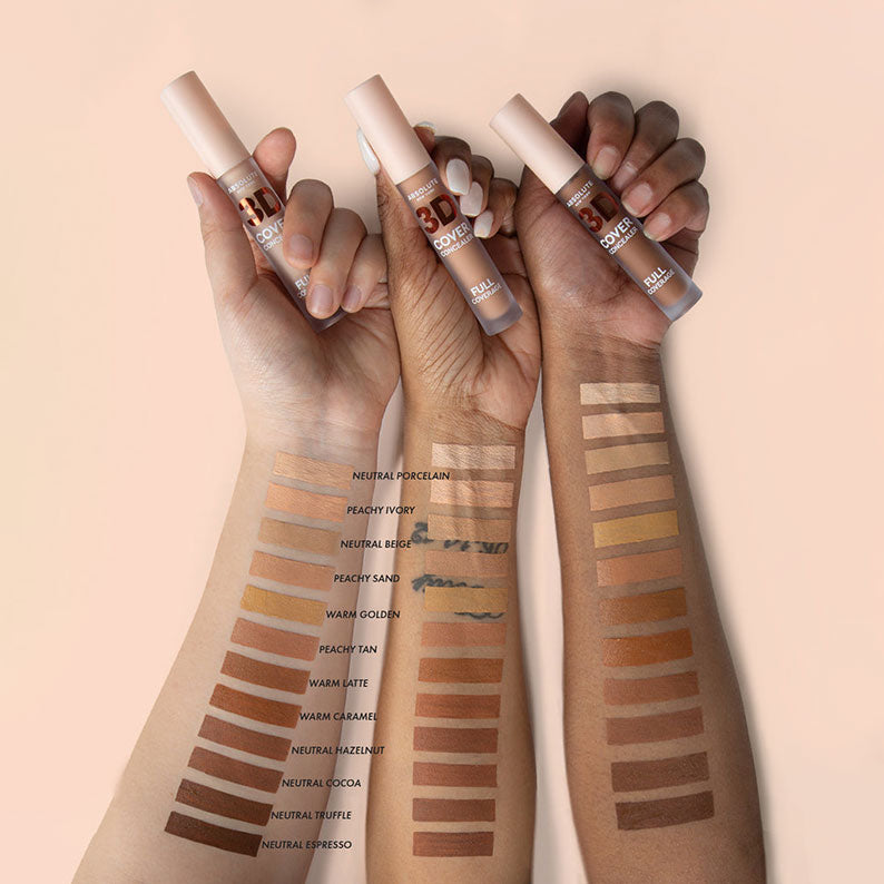 Absolute New York full coverage concealer shades swatched on three different skin tones with concealer tubes held in hands