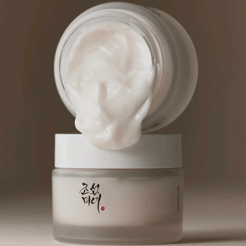 Beauty of Joseon Dynasty Cream moisturizer in frosted jar with creamy white texture spilling from open lid Korean herbal skincare