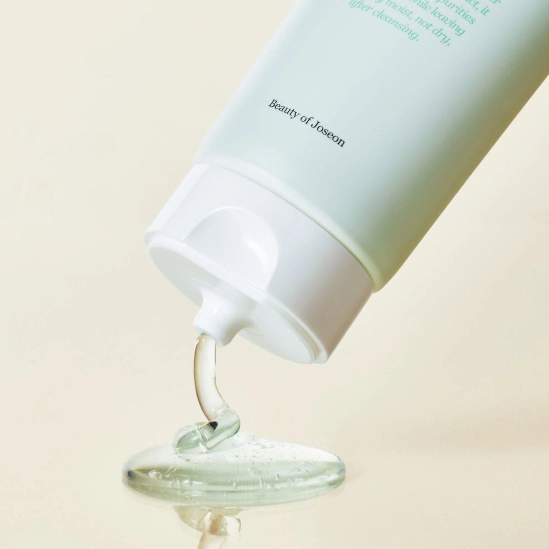 BEAUTY OF JOSEON green plum facial cleanser tube dispensing clear gel onto surface highlighting lightweight gentle cleansing
