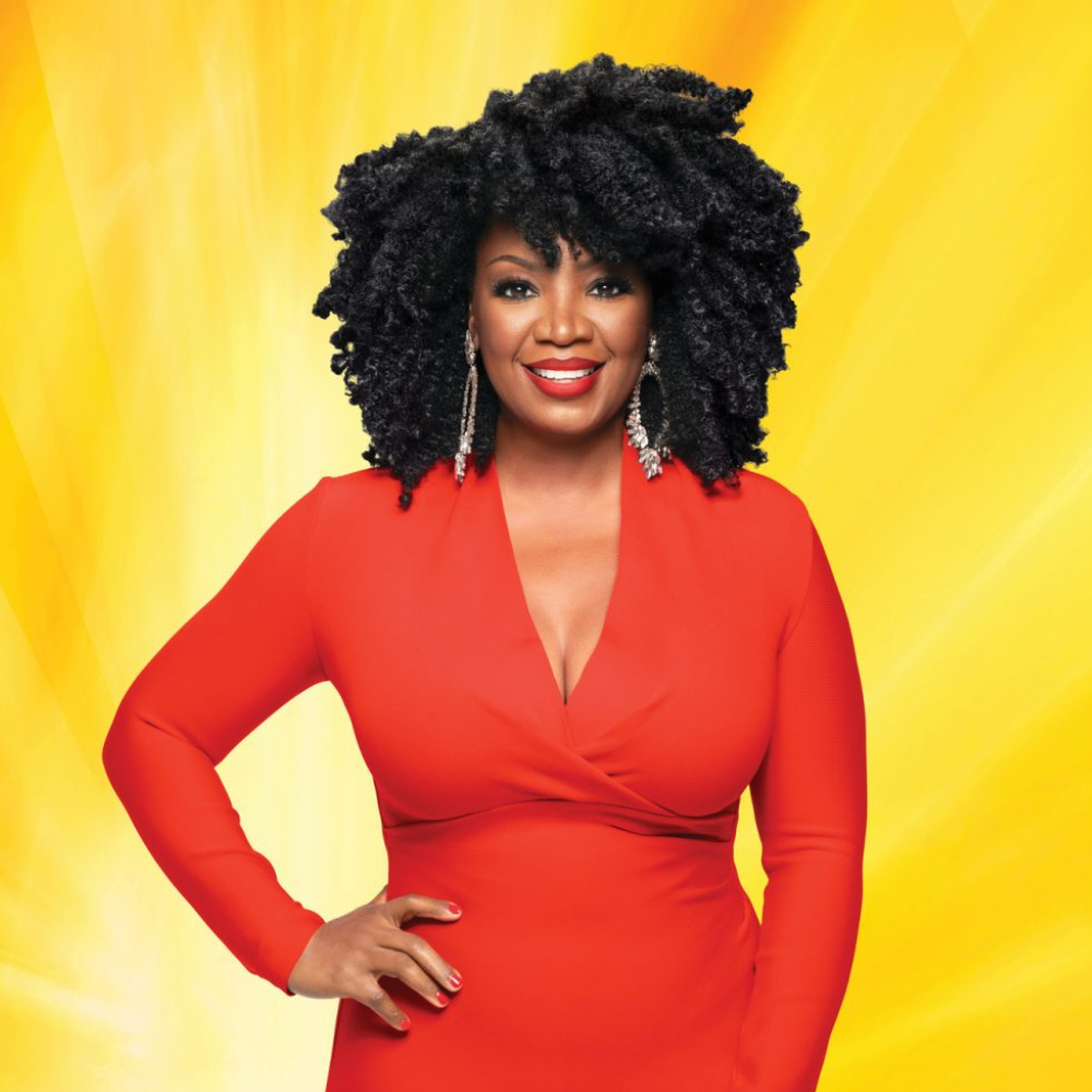 CREME OF NATURE sulfate free argan oil shampoo ad featuring smiling woman with natural curly hair in red dress