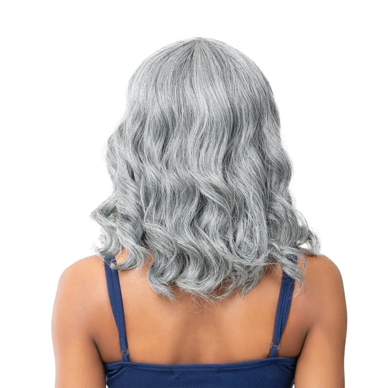 Back view of model wearing ITS A WIG silver wavy shoulder length premium synthetic wig with bangs