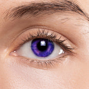 Close up of an eye wearing sweet violet color contact lenses by LIZ for bold makeup looks