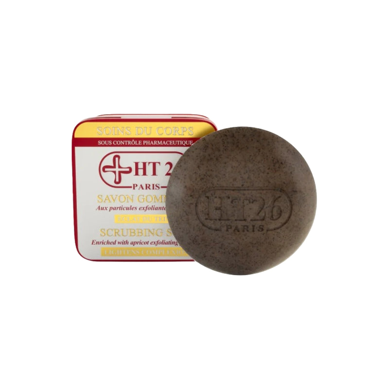 HT26 scrubbing soap round brown exfoliating bar embossed HT26 Paris beside red and yellow tin packaging
