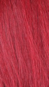 Close up of vibrant red straight wig hair showing smooth strands HD lace wig with natural hairline