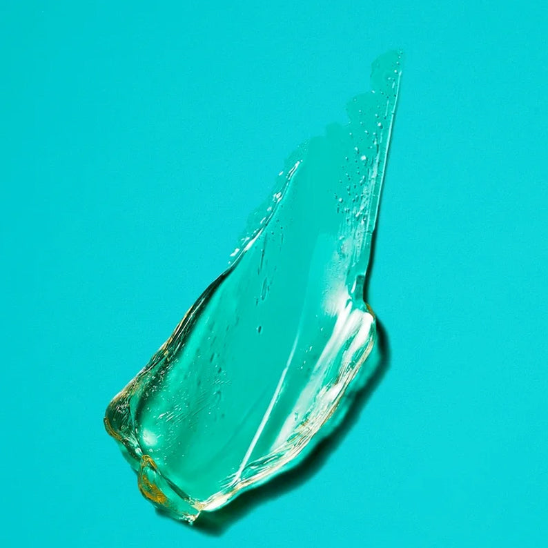 LETS JAM regular hold hair gel for shine clear gel smear on teal background showing glossy texture