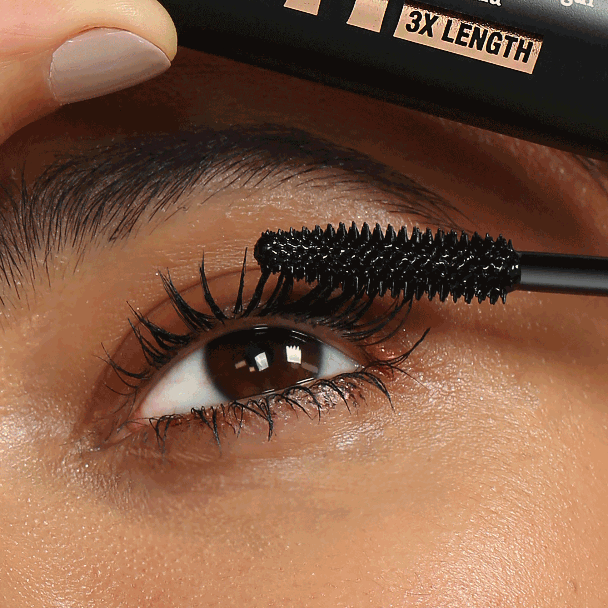 NICKA K volumizing mascara for long lashes being applied to upper eyelashes with black brush