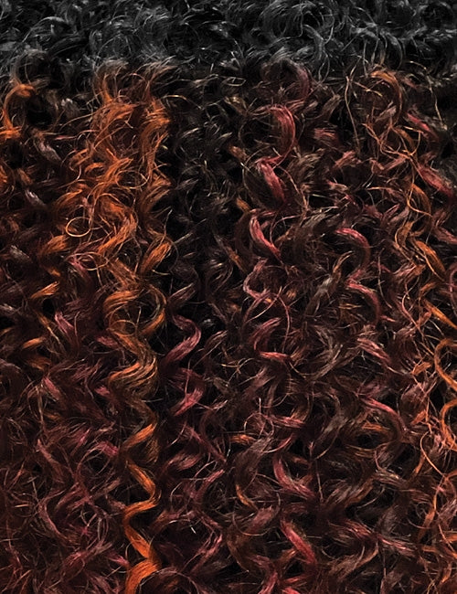 OUTRE afro clip in hair extensions close up of dark curly textured synthetic hair with auburn highlights