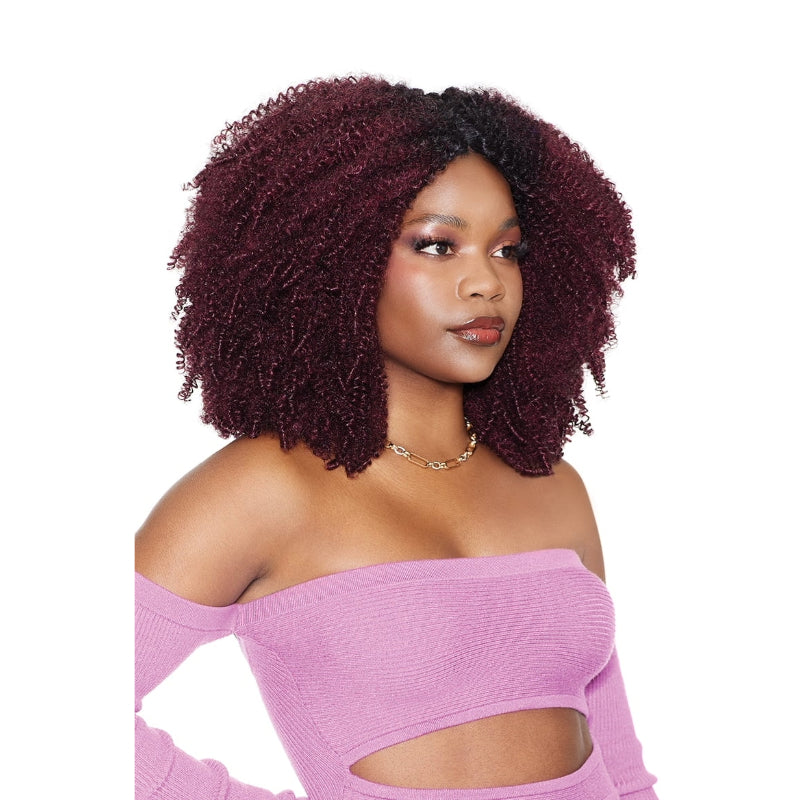 OUTRE Brazilian coily hair weave burgundy afro on model with voluminous natural curls wearing pink top