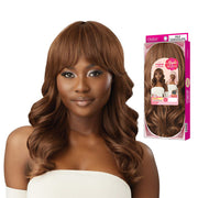 OUTRE synthetic full cap wig 20 inch milk chocolate long wavy style with bangs modeled on woman