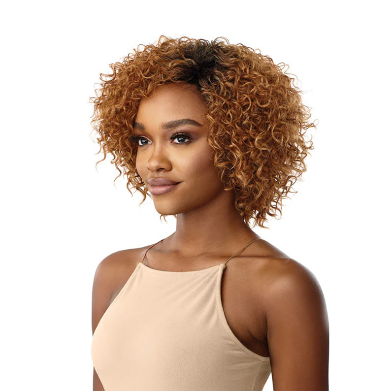 OUTRE honey blonde curly bob synthetic hair full cap wig on model with dark roots and natural texture
