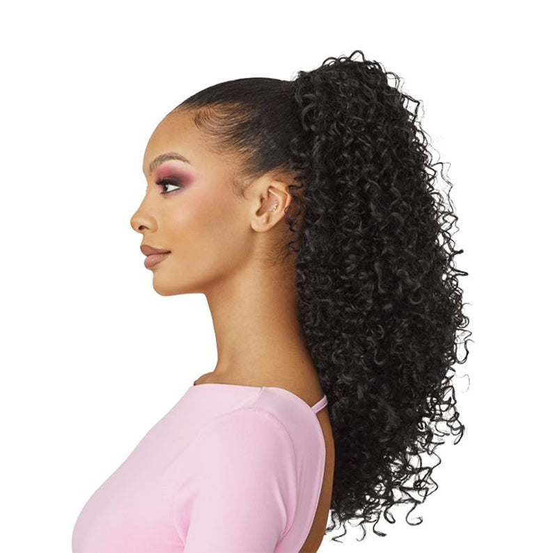 OUTRE curly ponytail extension in natural black on model with sleek high ponytail and defined curls