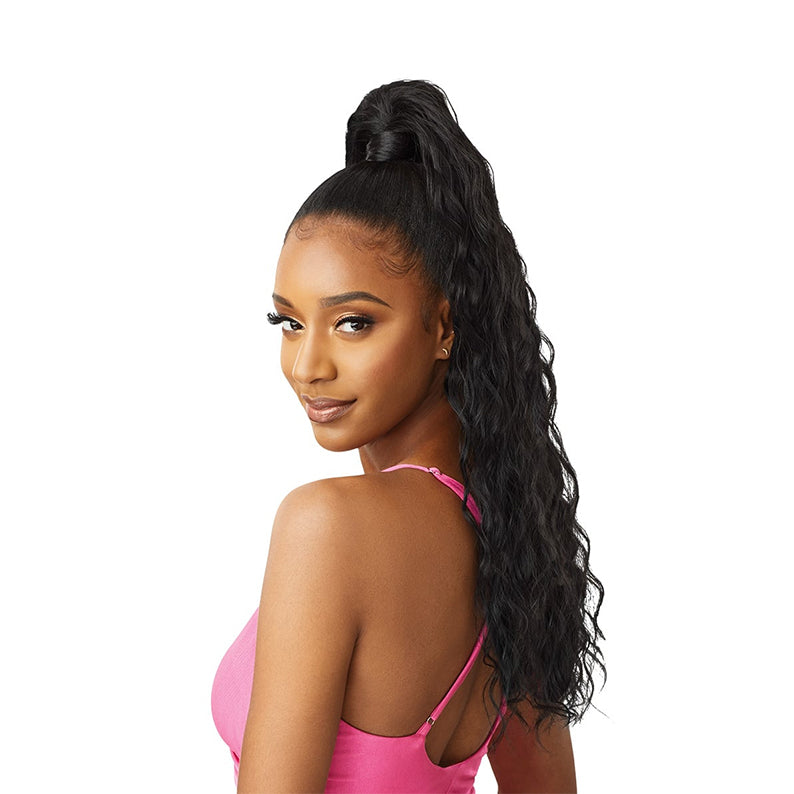 OUTRE natural wave ponytail extension worn by model with long black wavy hair in pink top
