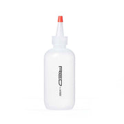 RED BEAUTY by KISS white hair dye applicator bottle with pointed nozzle and red twist cap for precise coloring