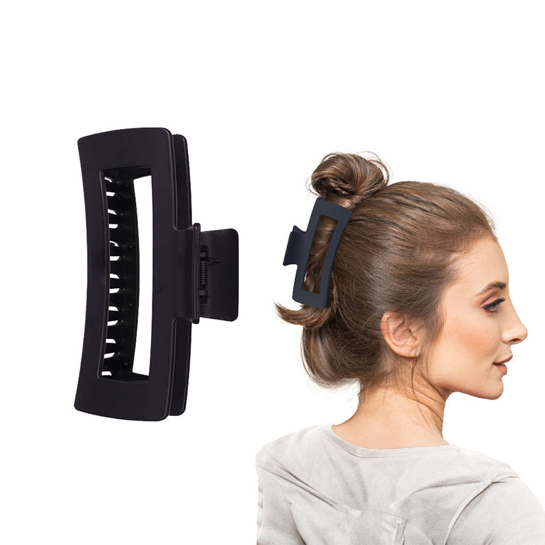 RED BEAUTY by KISS jumbo matte hair claw clip in black shown on model securing a casual top knot bun