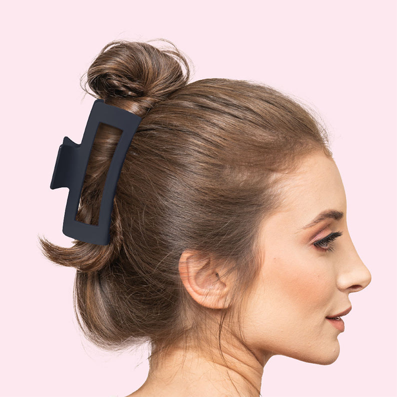 Woman with brown bun secured by jumbo matte hair claw clip black rectangular design for thick hair