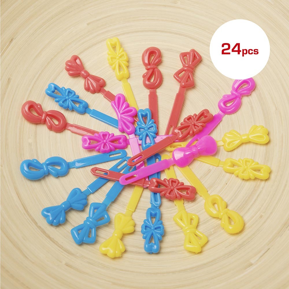 Pack of 24 colorful kids ribbon hair barrettes in pink blue red and yellow plastic bow clips on wooden background