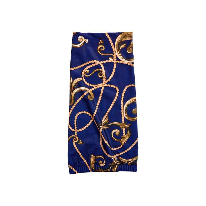RED BEAUTY by KISS open back dreadlock tube cap in blue with gold rope scroll print and elastic hem