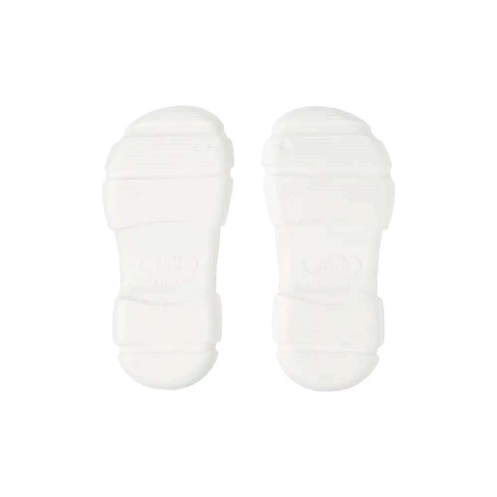 Pair of white air clog shoes soles isolated on black background lightweight cushioned non slip