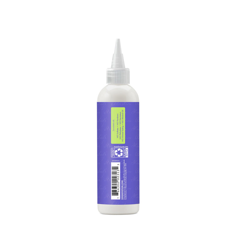 Shea Moisture anti-dandruff pre-wash white squeeze bottle with pointed nozzle and purple label back view
