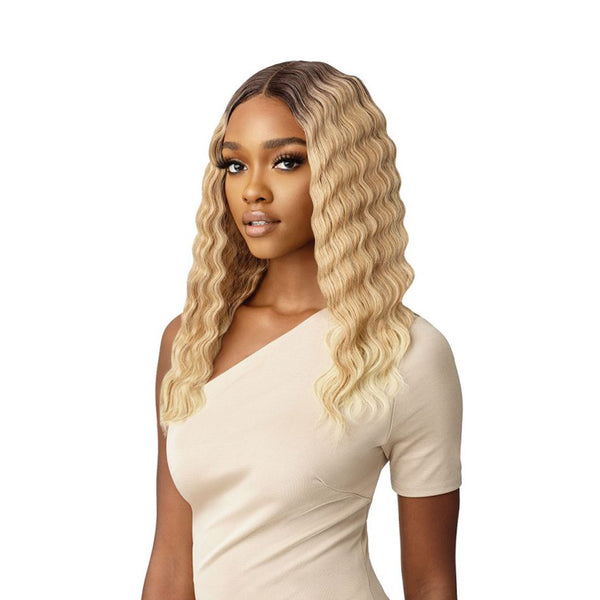OUTRE 18 inch lace front wig with long wavy blonde hair on a model wearing a beige top