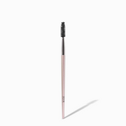 NICKA K eyebrow wand for shaping spoolie brush with slim rose gold handle and black bristles on white background
