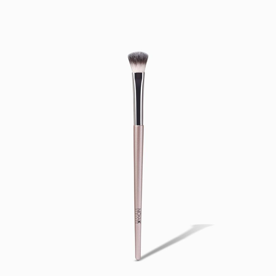 NICKA K powder eyeshadow brush with soft synthetic bristles and pink handle on white background