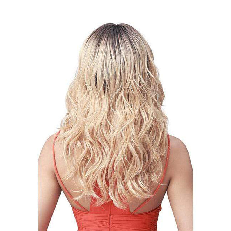 Back view of long wavy blonde Bobbi Boss Addison lace front wig with dark roots on model