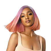 Model wearing COLORBOMB synthetic lace front wig pastel pink to peach sleek bob side part