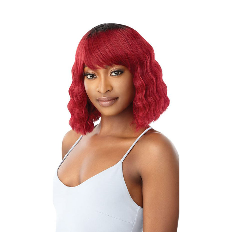 OUTRE Duby wig 100% human hair. Short wavy red bob with dark roots and side bangs on model