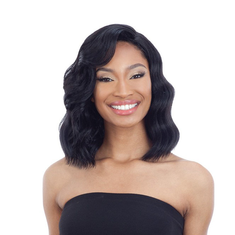 Smiling model wearing SHAKE N GO Freetress Equal 5 inch lace part wig. Shoulder length wavy black lace part bob