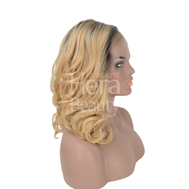 OUTRE blonde shoulder length wavy wig with dark roots shown on mannequin melted hairline lace front wig