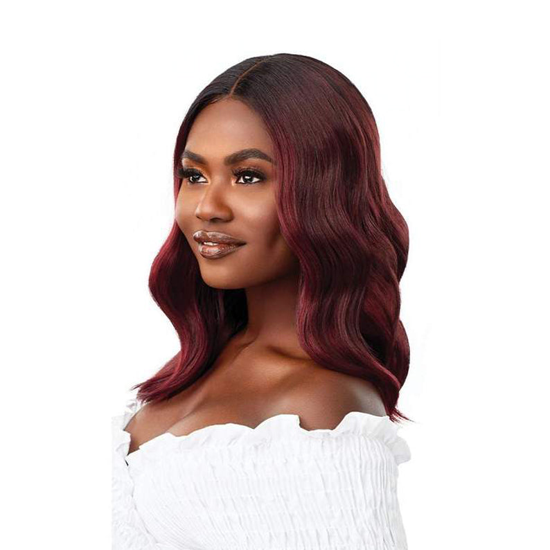 OUTRE 16 inch lace front wig in deep burgundy with soft waves on a woman