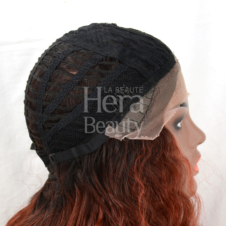 OUTRE lace front synthetic wig on mannequin showing lace front and open weft cap with auburn waves