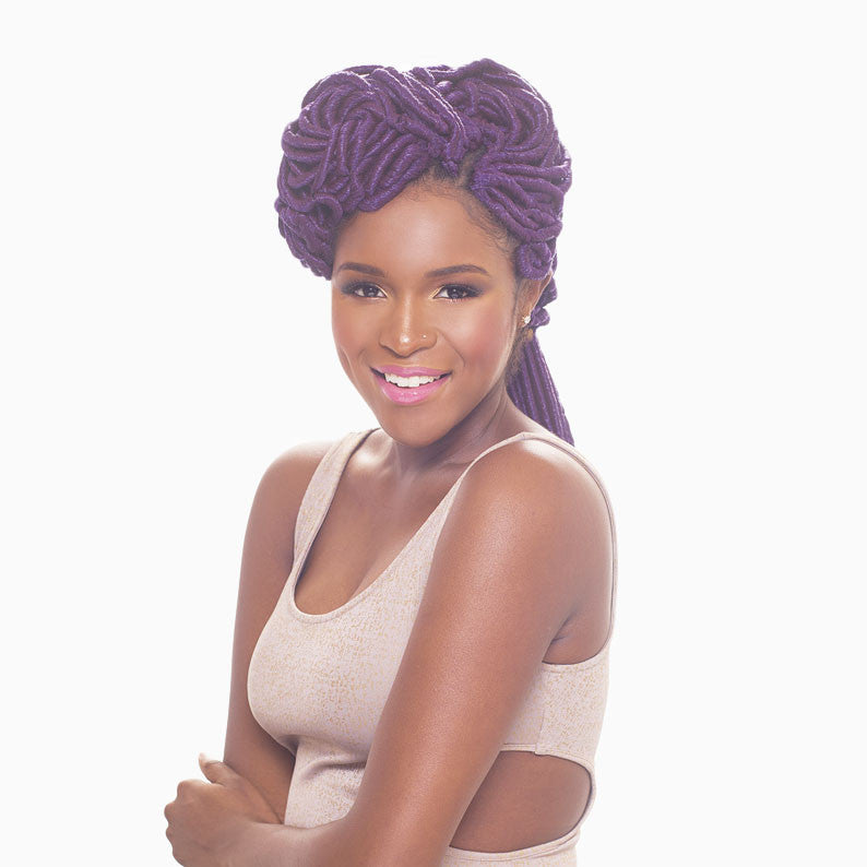 Smiling woman with purple mambo faux locs braids styled up wearing a beige sleeveless top