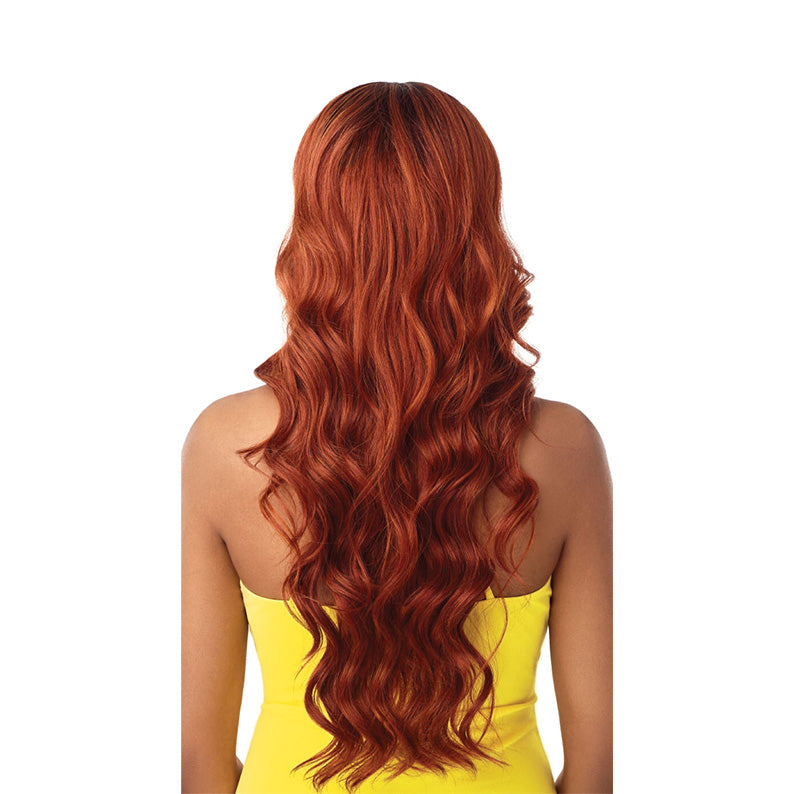 Kamala 26 inch synthetic lace wig. OUTRE long wavy copper red wig shown from back on model wearing yellow top