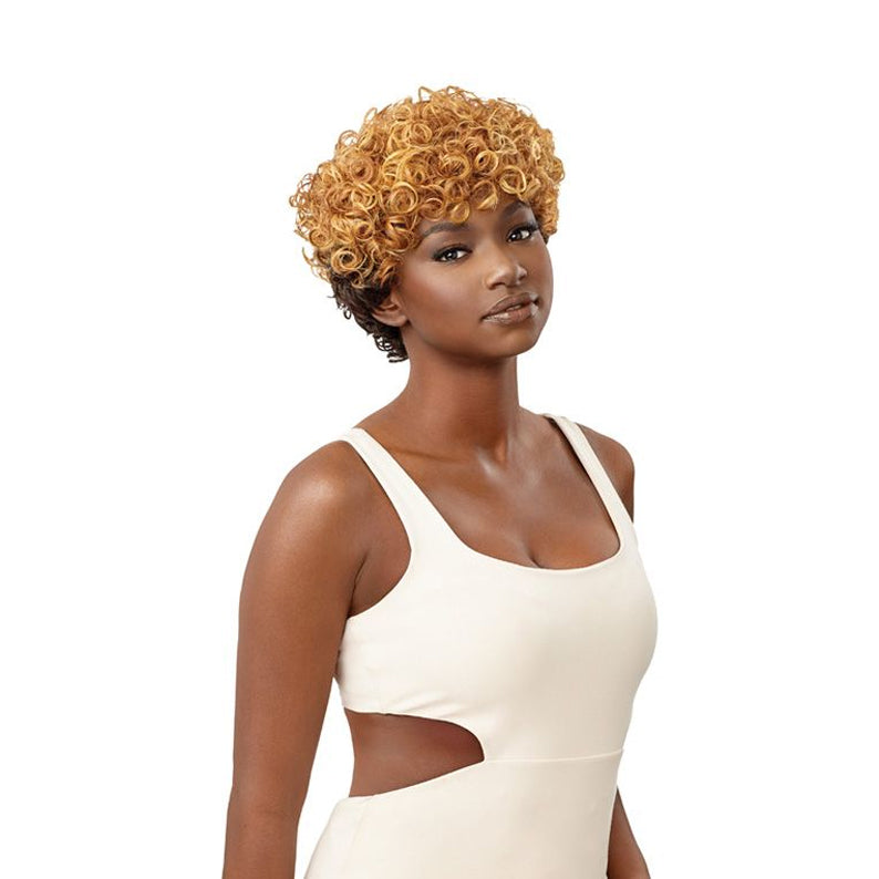 OUTRE short two tone honey blonde curly pixie on model wearing white cutout top synthetic curly wig for women