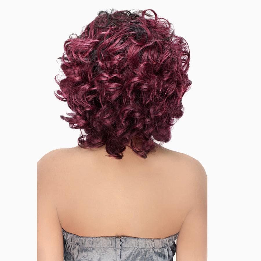 Back view of short burgundy curly wig with dark roots on model wearing strapless top jade swirl wig 3 piece set