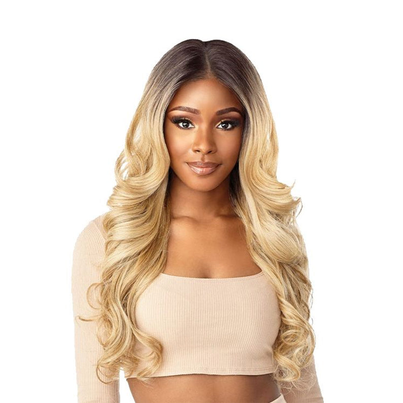 Model wearing Sensationnel Cloud 9 Rashana HD lace wig long blonde ombre waves with natural center part and lace hairline